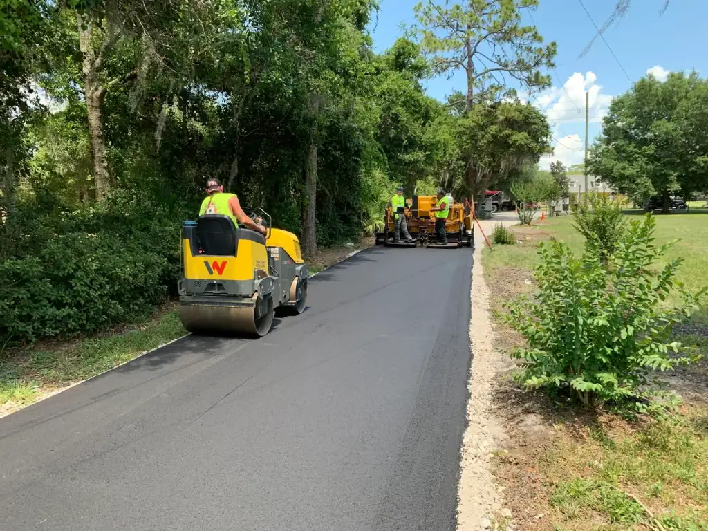 Hot asphalt paving by Central Florida Blacktop Paving company on outdoor green space.