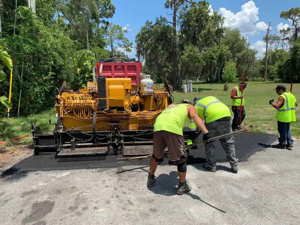 Asphalt paving process by Central Florida Blacktop Paving team on a sunny day.